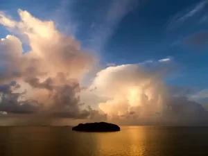 Florida sunset with island and fluffy clouds